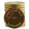 A stack of gold-colored tokens with text and numbers on the front token. Produktbild-Vorschau