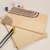 A partially painted wooden board with paint pots and brushes. Produktbild-Vorschau