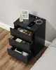 A black bedside table with drawers open, displaying various items. Náhled obrázku produktu