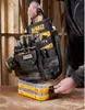 A person is holding a DeWalt tool bag over a stack of yellow and clear plastic storage containers. Anteprima dell’immagine prodotto