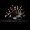 A man is shown with multiple arms, cooking with a pot on a stove. Produktbild-Vorschau