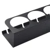 A black metal spray can organizer with multiple circular openings for cans. Produktbild-Vorschau