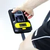 A hand is placing a smartphone into a holder on an elliptical trainer. Anteprima dell’immagine prodotto