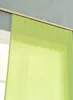 A close-up of a light green curtain hanging from a curtain rod. Produktbild-Vorschau