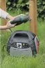 A person is using a jigsaw powered by a portable power station in a grassy outdoor setting. Podgląd zdjęcia produktu