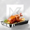 A roasted chicken with potatoes and herbs in a roasting pan, with a large graphic overlay in the background. Voir les images du produit