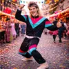 A man in a retro tracksuit dancing in a street party with confetti falling. Anteprima dell’immagine prodotto