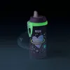 A NUK Kiddy Cup with a glow-in-the-dark feature, set against a dark background. Produktbild-Vorschau