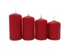 Four red pillar candles of varying heights arranged in a row against a white background. Produktbild-Vorschau