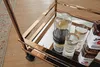 A close-up shot of a bar cart with bottles of bourbon and glasses. Voir les images du produit