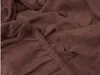 A close-up view of a dark brown terry cloth bed sheet, showing the texture of the fabric and the elasticated edge. Produktbild-Vorschau