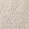 A close-up, textured view of a cream-colored microfiber blanket. Podgląd zdjęcia produktu