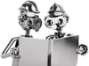 Two metal figures made from nuts, bolts, and other hardware, appearing to be engineers or technicians, are looking at a metallic object together. Produktbild-Vorschau