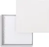 A white spiral-bound notebook is placed inside a white box, with the lid of the box open and placed next to it. Produktbild-Vorschau
