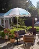 A garden patio with outdoor furniture and a parasol. Produktbild-Vorschau