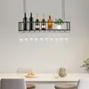 A hanging wine rack with bottles and glasses above a dining table. Podgląd zdjęcia produktu
