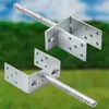 Two galvanized steel post anchors with rebar stakes are shown against a blurred green and blue background. Produktbild-Vorschau