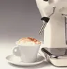 A close-up shot of a vintage-style espresso machine with a cup of cappuccino in the foreground. Podgląd zdjęcia produktu