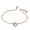 A rose gold bracelet with a pink clover-shaped charm and clear crystals, displayed on a white background. Anteprima dell’immagine prodotto
