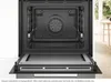 The interior of an open Bosch oven with the door lowered. Produktbild-Vorschau