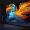 A person stands in a dark room looking at a large, vibrant, abstract digital art display. Náhled obrázku produktu
