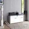 A shoe bench with a cushioned seat in a hallway next to a staircase, with a mirror and umbrella stand in the background. Voir les images du produit