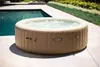 An inflatable hot tub is situated on a patio next to a swimming pool. Náhľad obrázku produktu