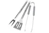 A set of three stainless steel barbecue tools, including a fork, spatula, and tongs, arranged diagonally on a white background. Anteprima dell’immagine prodotto