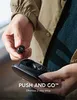 A person is holding a wireless earbud and a charging case. Voir les images du produit