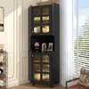 A black corner cabinet with glass doors and LED lighting is shown in a room with natural light coming from a window. Anteprima dell’immagine prodotto