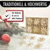 Christmas decorations, including straw stars and a red bauble, are displayed on a festive background with pine branches. Produktbild-Vorschau