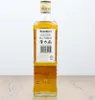A bottle of Bushmills Irish Whiskey stands on a wooden surface against a white background. Produktbild-Vorschau