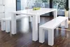 A white dining table with two benches in a modern dining room. Produktbild-Vorschau