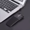A black wireless mouse is placed next to a silver laptop on a black surface. Náhľad obrázku produktu