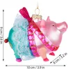 A pink glass pig ornament with a teal tutu and a pink scarf, with measurement indicators. Podgląd zdjęcia produktu
