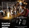 A man is working on a laptop at a bar counter, with a bottle lamp and beer glasses on the counter. Anteprima dell’immagine prodotto