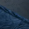 A close-up view of two pieces of blue fabric with a floral pattern, separated by a seam. Produktbild-Vorschau