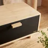 A close-up view of a bread box with a black front and a bamboo lid and sides. Náhled obrázku produktu