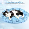 A black and white cat is lying on a round, light blue pet bed with snowflake patterns. Produktbild-Vorschau