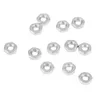 A collection of small metal nuts on a white background. Anteprima dell’immagine prodotto
