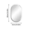 A frameless oval mirror with dimensions indicated. Voir les images du produit