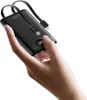 A hand holding a black power bank with integrated cables. Produktbild-Vorschau