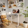 A modern home office setup featuring a white standing desk with a computer, a brown leather chair, and shelves with decorative items and books. Produktbild-Vorschau
