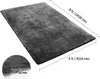 A dark gray shaggy rug is shown with dimensions indicated by lines and text. Anteprima dell’immagine prodotto