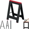 A black and red sawhorse stand is shown against a white background. Smaller images of the stand in different configurations are shown at the bottom left, and a close-up of a hand using a circular saw on a piece of wood is shown at the bottom right. Produktbild-Vorschau