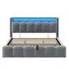 A grey upholstered bed frame with a slatted mattress base and blue LED lighting along the headboard. Náhled obrázku produktu