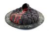 A dark, bubble-shaped cake with red 'lava' flowing from a broken sphere on top, presented on a dark, textured plate. Anteprima dell’immagine prodotto