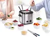 People are preparing and cooking food using a fondue pot. Produktbild-Vorschau