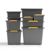 A stack of grey storage boxes with yellow handles against a white background. Produktbild-Vorschau