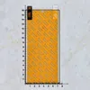 A screen protector is laid flat on a marble-patterned background with a ruler for scale. Náhled obrázku produktu